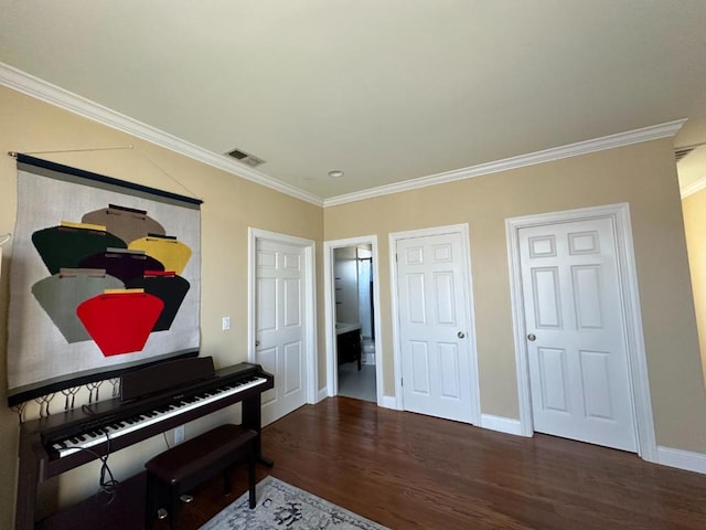 miscellaneous room with crown molding and hardwood / wood-style flooring