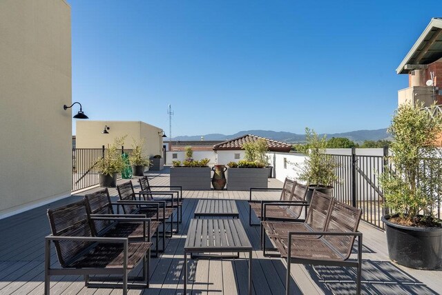 deck with an outdoor living space and a mountain view