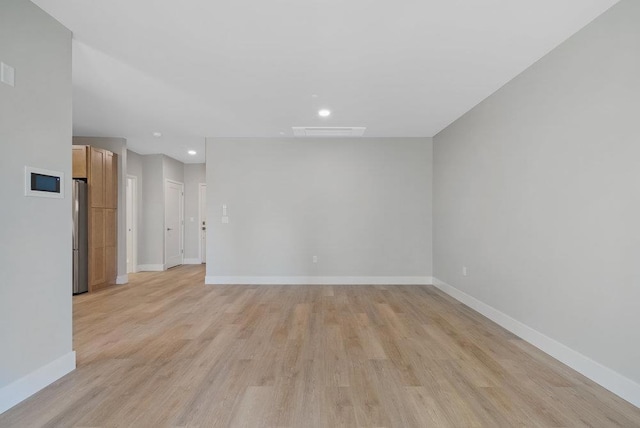 spare room with light hardwood / wood-style flooring