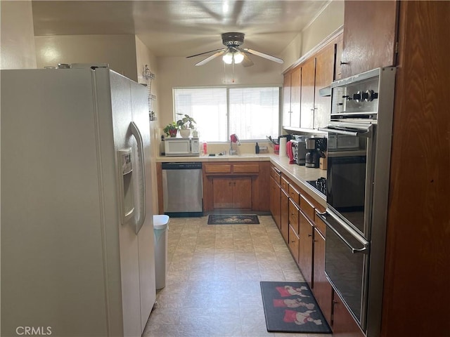 kitchen with ceiling fan, appliances with stainless steel finishes, and sink