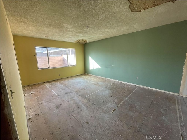 spare room with a textured ceiling