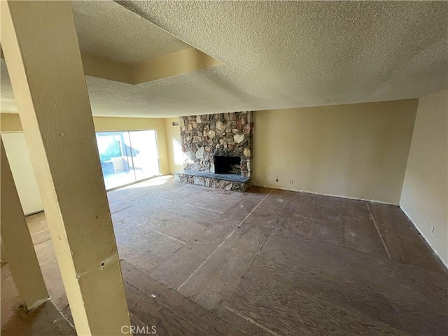 unfurnished living room featuring a textured ceiling and a fireplace