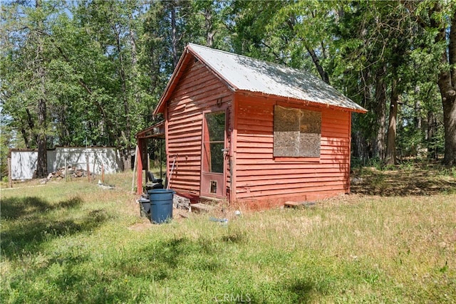 view of outbuilding featuring a lawn