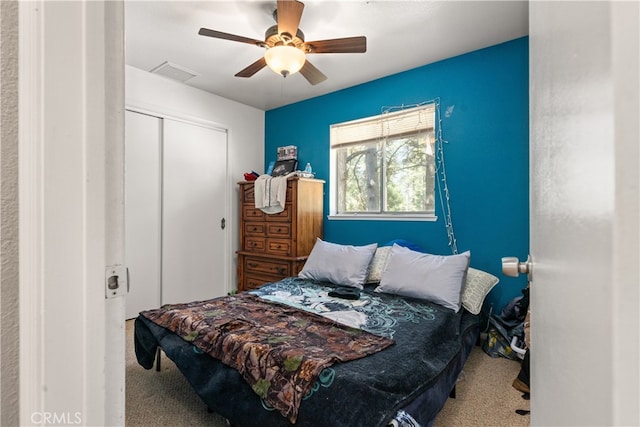 bedroom with carpet flooring, a closet, and ceiling fan