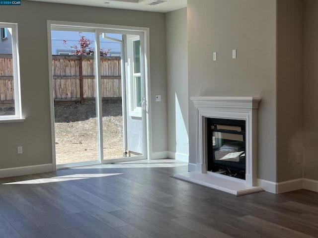 unfurnished living room with dark hardwood / wood-style floors