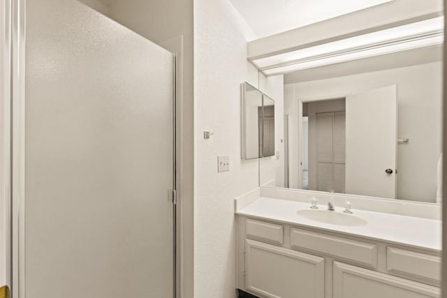 bathroom with an enclosed shower and vanity