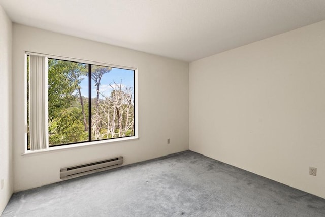 spare room featuring carpet floors and a baseboard radiator