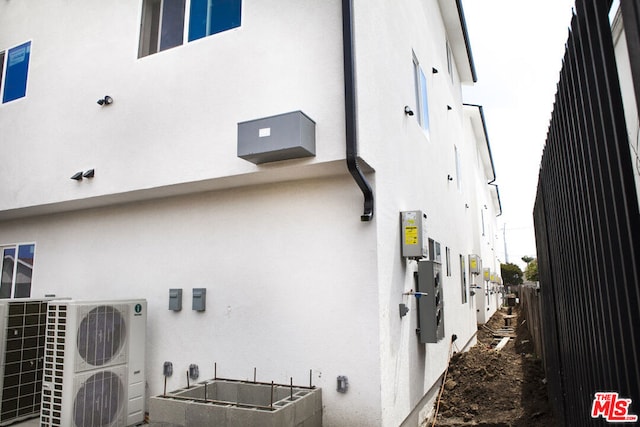 view of side of home featuring ac unit