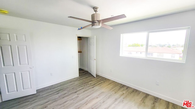 unfurnished bedroom with light wood-type flooring and ceiling fan