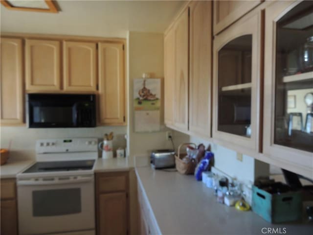 kitchen featuring light brown cabinetry and electric stove