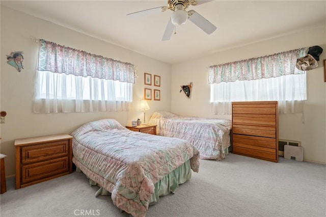 bedroom featuring light carpet and ceiling fan