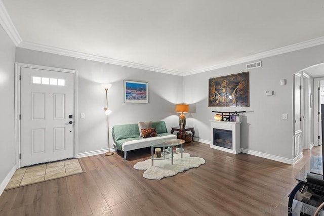 entrance foyer with ornamental molding and hardwood / wood-style flooring