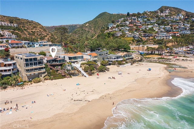 view of mountain feature featuring a view of the beach and a water view