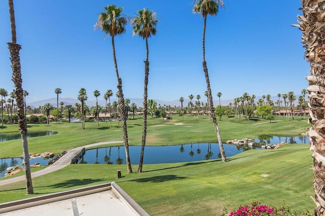 view of community with a lawn and a water view