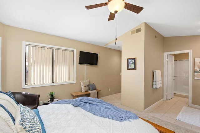 bedroom with ensuite bath, ceiling fan, light tile patterned floors, and lofted ceiling