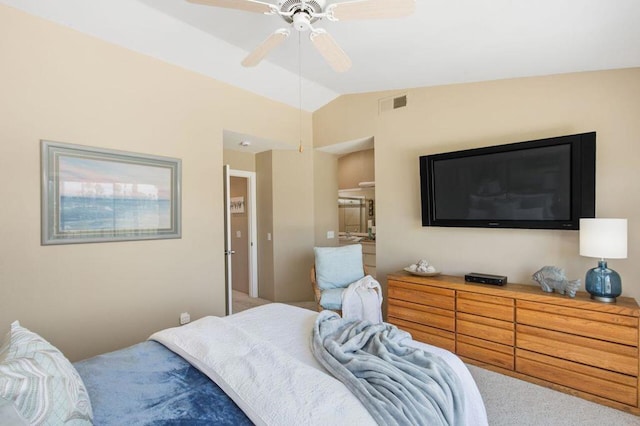 carpeted bedroom with ceiling fan and vaulted ceiling