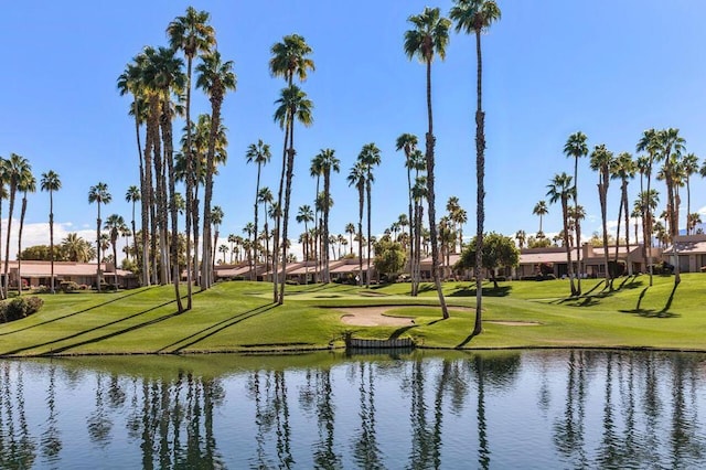 view of community with a lawn and a water view