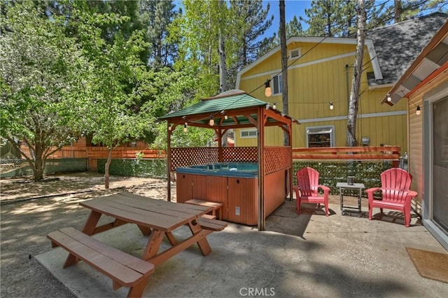 view of patio / terrace with a gazebo and a hot tub