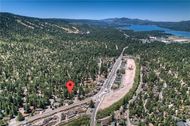 drone / aerial view featuring a water and mountain view