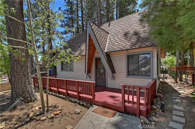 rear view of property with a wooden deck