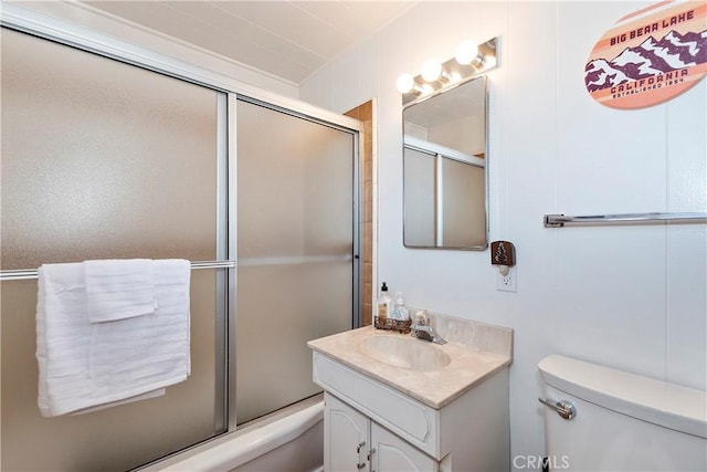 bathroom featuring vanity, toilet, and a shower with door