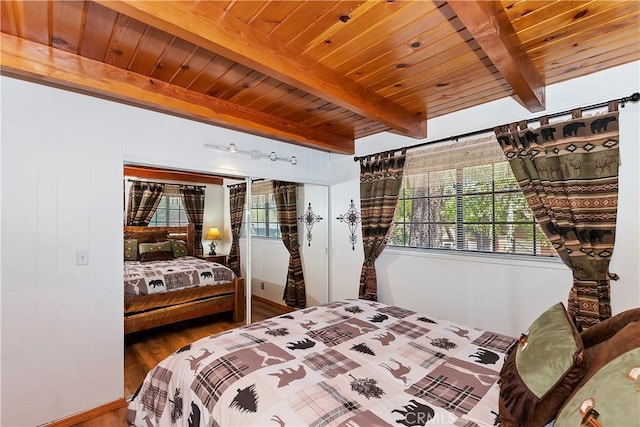 bedroom featuring beamed ceiling, wooden ceiling, and hardwood / wood-style flooring