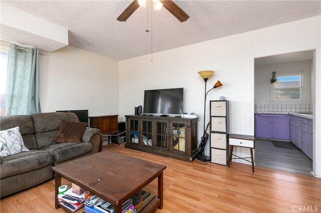 13115 Davenport St, North Edwards, CA 93523 - living area with ceiling fan, a textured ceiling, and light wood-style floors