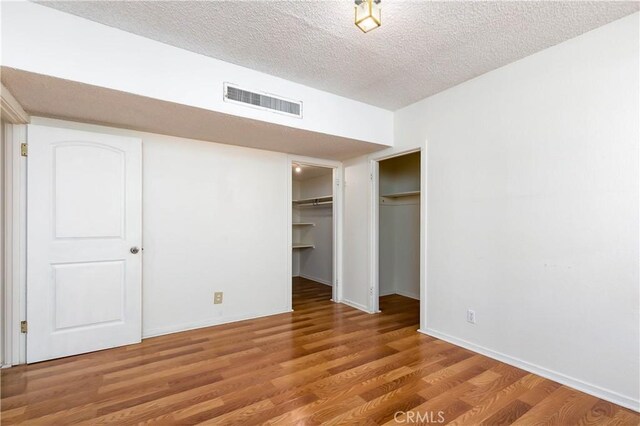 13115 Davenport St, North Edwards, CA 93523 - unfurnished bedroom with wood finished floors, a textured ceiling, and baseboards