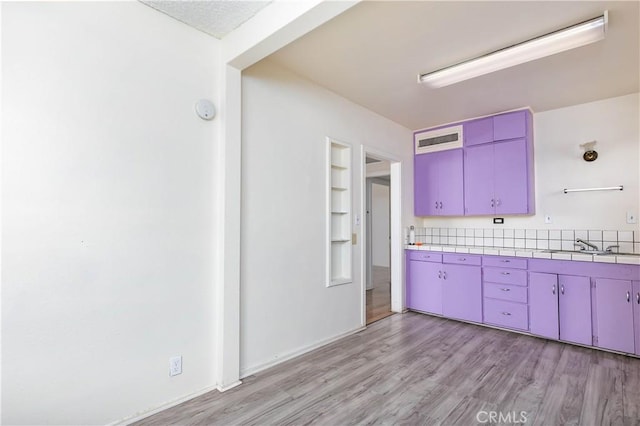 13115 Davenport St, North Edwards, CA 93523 - kitchen featuring tile countertops, light wood-type flooring, a sink, and red cabinets