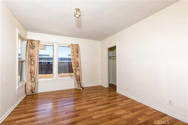 13115 Davenport St, North Edwards, CA 93523 - unfurnished bedroom featuring wood finished floors, a textured ceiling, a closet, and baseboards