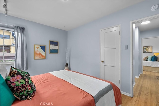 bedroom with light hardwood / wood-style flooring