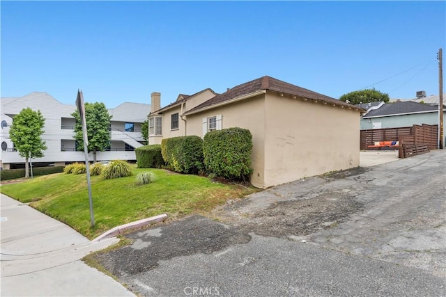 view of property exterior with a yard