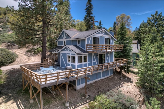 back of house featuring a deck