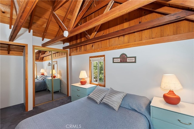 carpeted bedroom with a closet, vaulted ceiling with beams, and wood ceiling