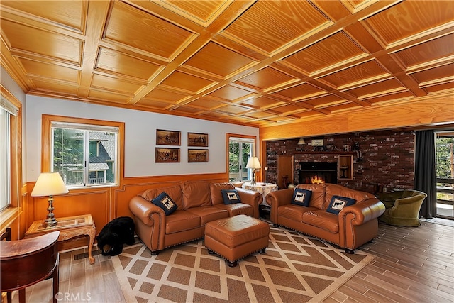 living room with plenty of natural light, coffered ceiling, and a fireplace