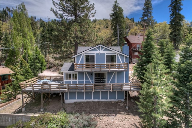 rear view of house featuring a deck