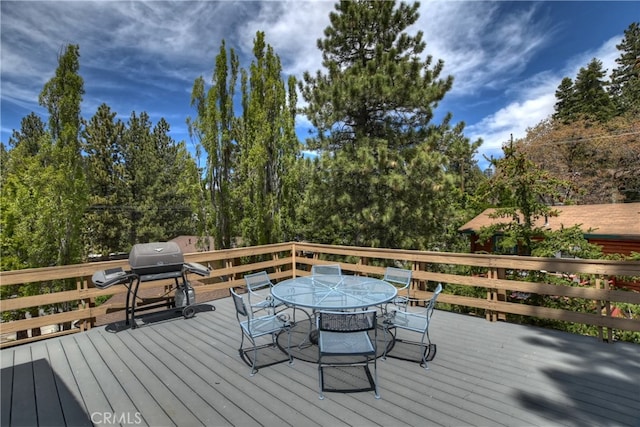 wooden deck featuring a grill