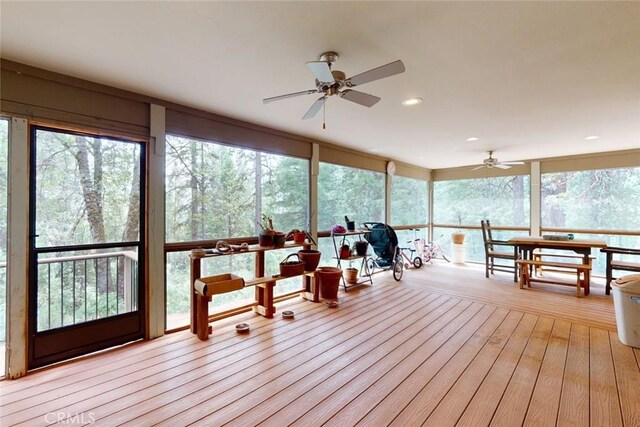 sunroom featuring ceiling fan