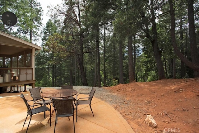 view of patio featuring a sunroom