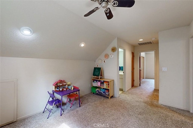 playroom featuring ceiling fan, lofted ceiling, and light carpet