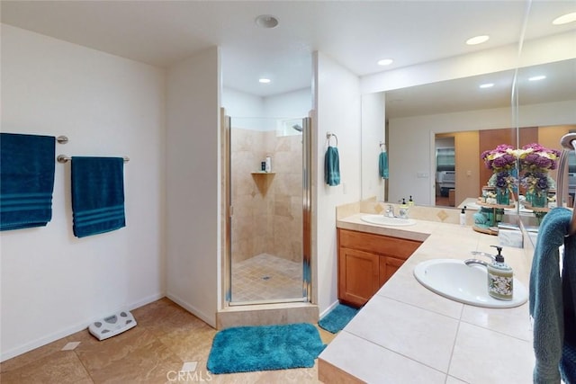 bathroom with tile patterned flooring, vanity, and a shower with shower door