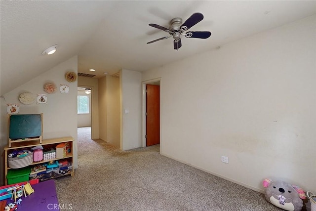 playroom featuring carpet flooring, ceiling fan, and vaulted ceiling