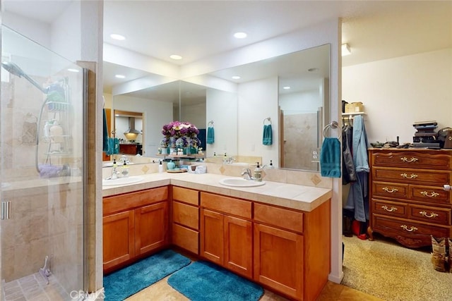 bathroom with tile patterned floors, vanity, and an enclosed shower