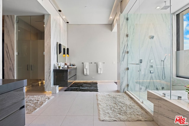 bathroom with tile patterned flooring, vanity, floor to ceiling windows, and walk in shower