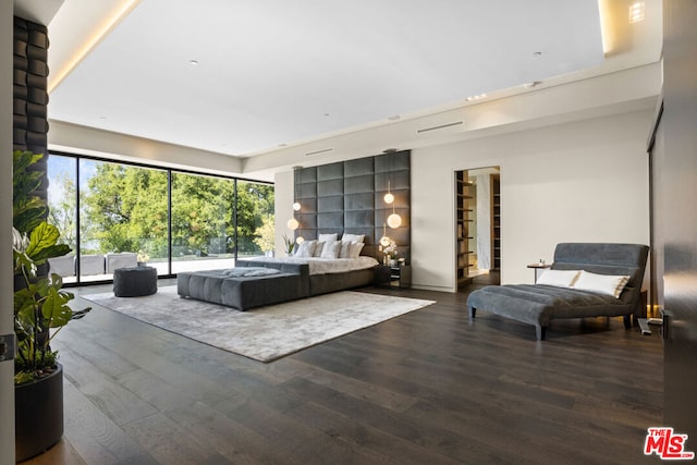 bedroom featuring access to exterior and dark wood-type flooring