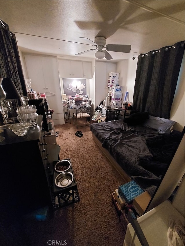 bedroom featuring carpet, ceiling fan, and a textured ceiling