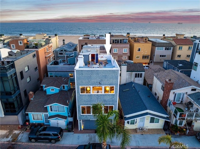 aerial view at dusk with a water view