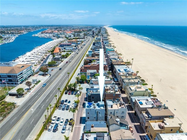 bird's eye view featuring a view of the beach and a water view