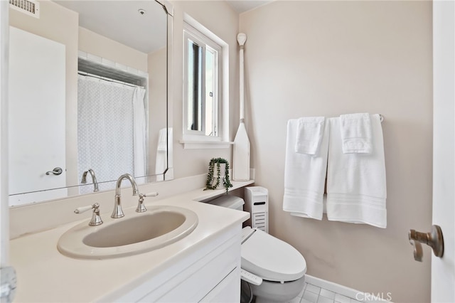 bathroom featuring tile patterned floors, vanity, and toilet