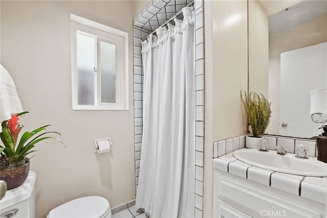 bathroom with a shower with curtain, vanity, toilet, and tile patterned floors